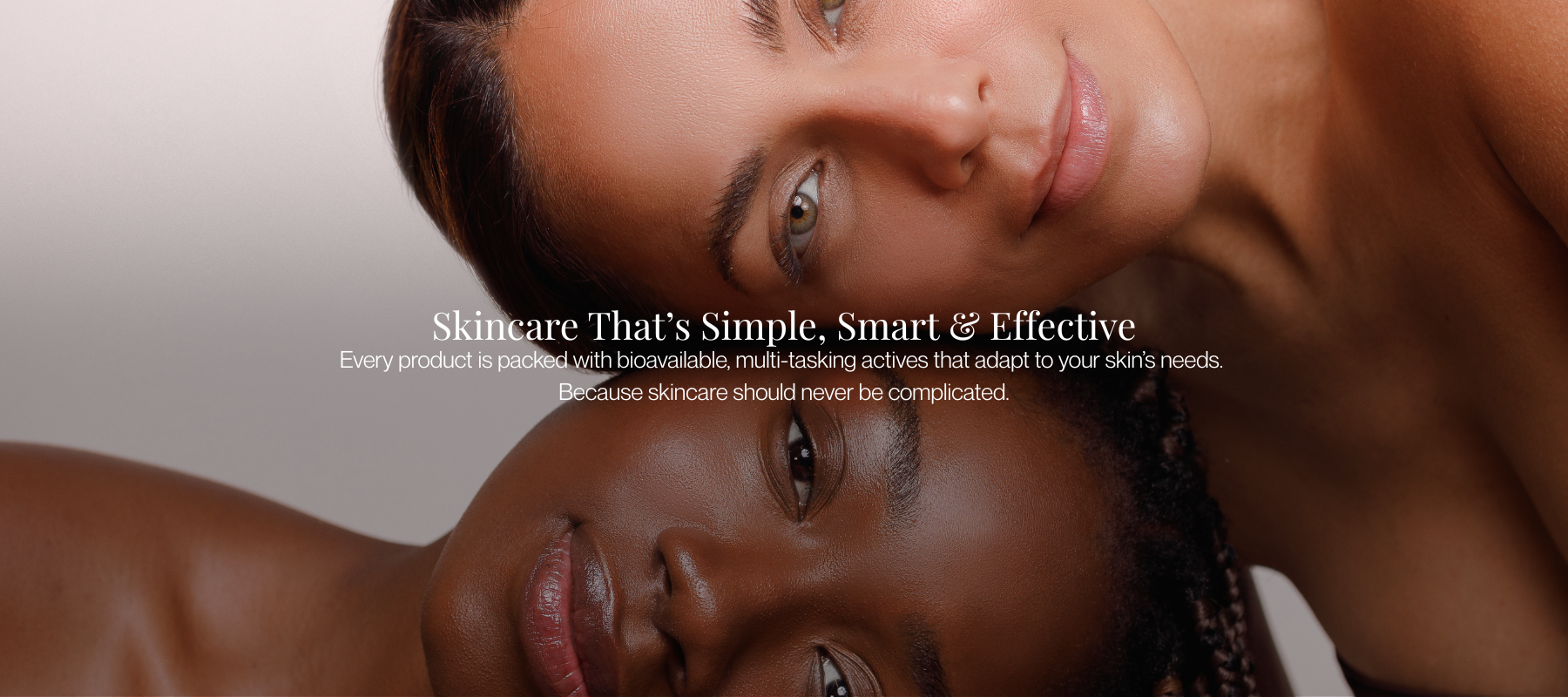 Two women with glowing skin embracing, representing Bossa Skin's clean, science-backed skincare made with bioavailable, multi-tasking ingredients.